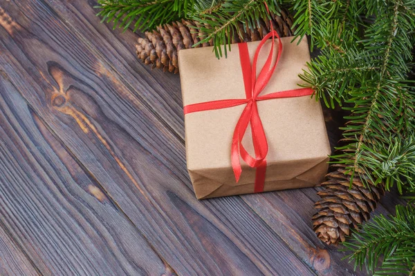 Christmas tree branch, decorations and gift box on white wooden table — Stock Photo, Image