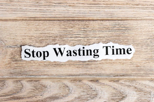 Stop Wasting Time text on paper. Word Stop Wasting Time on torn paper. Concept Image