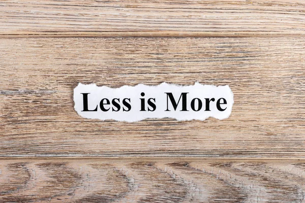 Less is more text on paper. Word less is more on torn paper. Concept Image — Stock Photo, Image