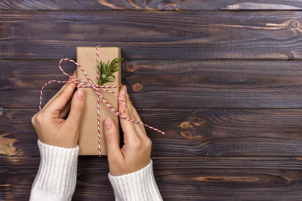 Donna in possesso di una confezione regalo in un gesto di dare — Foto Stock