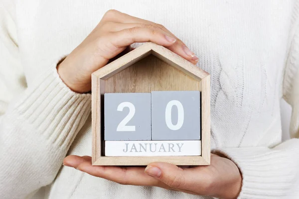 January 20 in the calendar. the girl is holding a wooden calendar. inauguration day