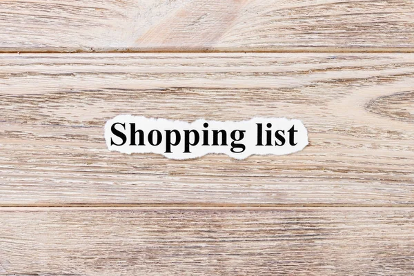Boodschappenlijstje van het woord op papier. concept. Woorden van Shopping List op een houten achtergrond — Stockfoto