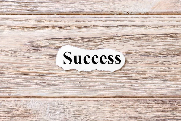 Success of the word on paper. concept. Words of Success on a wooden background — Stock Photo, Image