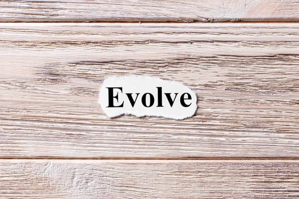 EVOLVE of the word on paper. concept. Words of EVOLVE on a wooden background — Stock Photo, Image