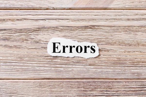 Kağıt üzerinde kelime hataları. kavram. Ahşap arka plan üzerinde hatalardan kelimeler