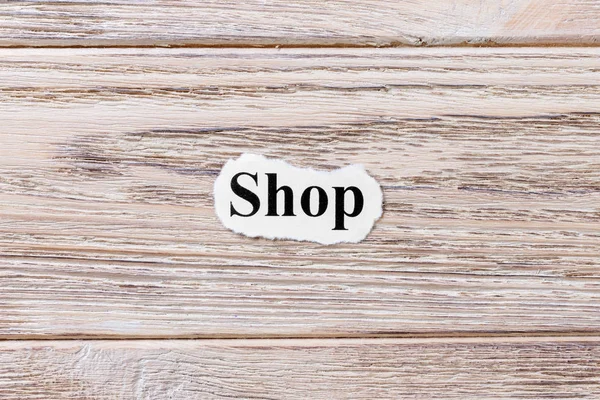 Winkel van het woord op papier. concept. Woorden van winkel op een houten achtergrond — Stockfoto