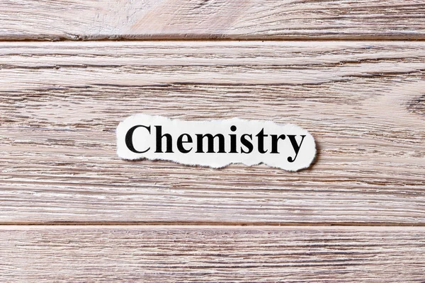 在纸上的化学字。概念.木制背景下的化学词汇 — 图库照片