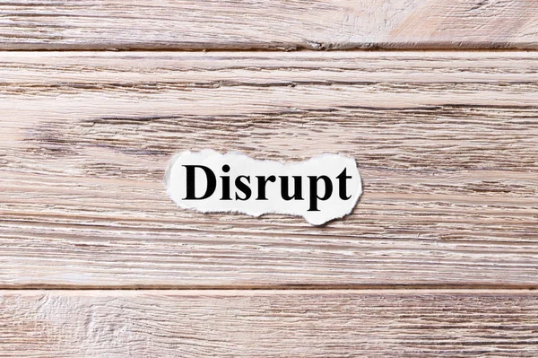 DISRUPT of the word on paper. concept. Words of DISRUPT on a wooden background — Stock Photo, Image