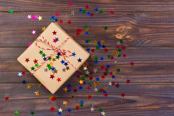 Простой рождественский подарок с красной бечевкой и звездами декора — стоковое фото