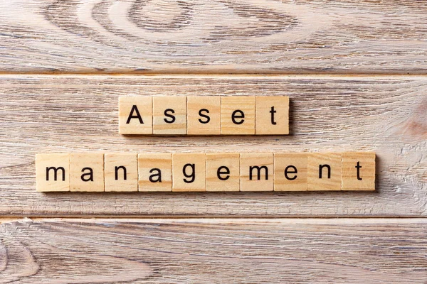 Asset Management word written on wood block. Asset Management text on table, concept