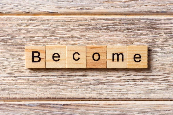 Become word written on wood block. Become text on table, concept — Stock Photo, Image