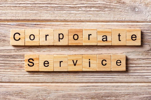 CORPORATE SERVICE word written on wood block. CORPORATE SERVICE text on table, concept