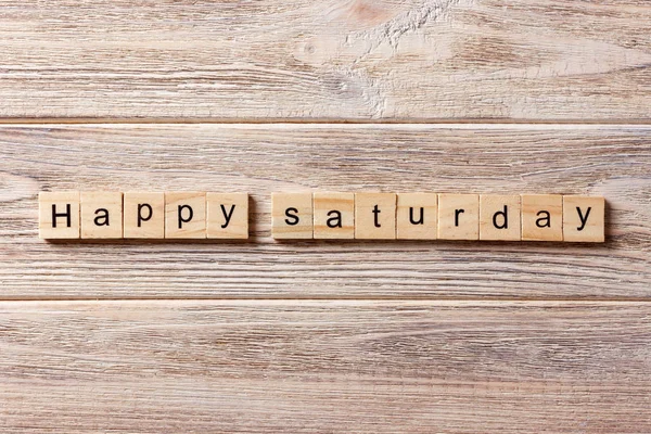 Happy Saturday word written on wood block. Happy Saturday text on table, concept