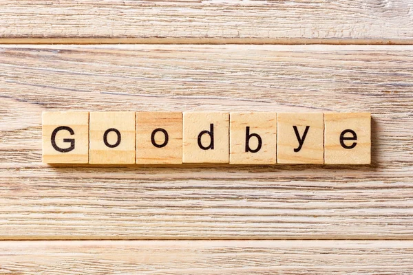 Goodbye word written on wood block. Goodbye text on table, concept — Stock Photo, Image