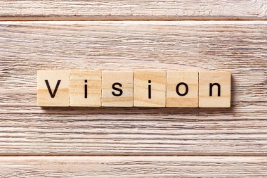 Vizyon kelime ahşap blok üzerinde yazılı. Vizyon tablo, metin kavramı
