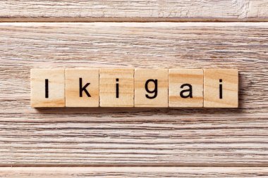 ikigai word written on wood block. ikigai text on table, concept clipart