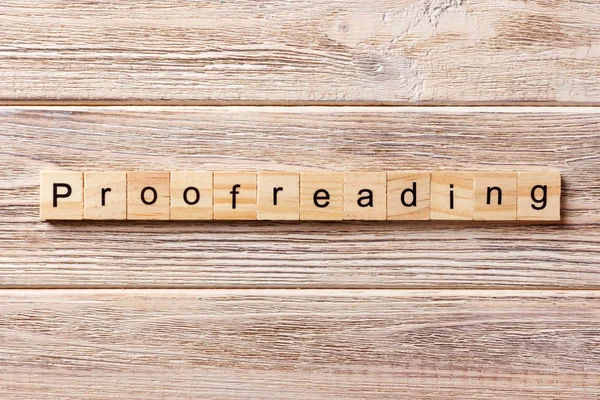 Proofreading word written on wood block. proofreading text on table, concept — Stock Photo, Image