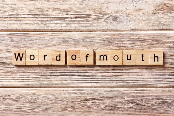 Word of Mouth word written on wood block. Word of Mouth text on table, concept