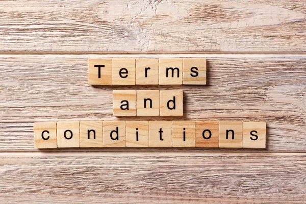 Terms and Conditions word written on wood block. Terms and Conditions text on table, concept