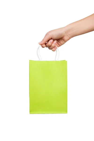 Vrouw hand houdt een helder groene tas voor winkelen geïsoleerd op witte achtergrond — Stockfoto