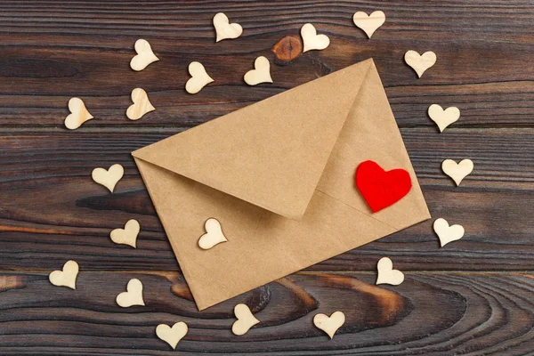 love letter envelope with red heart on wooden background