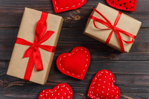 Gift box with fabric hearts on Black wooden table — Stock Photo, Image