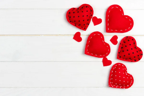 Valentines day background with handmade toy hearts on wooden table — Stock Photo, Image
