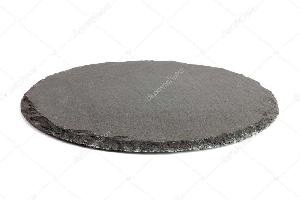 Round rustic black slate stone plate, isolated on white background
