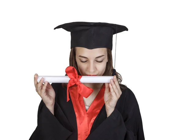 Happy young woman in graduation gown kiss diploma — Stock Photo, Image
