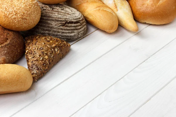 Assorted of bread on white wooden background. top view with copy space — Stock Photo, Image