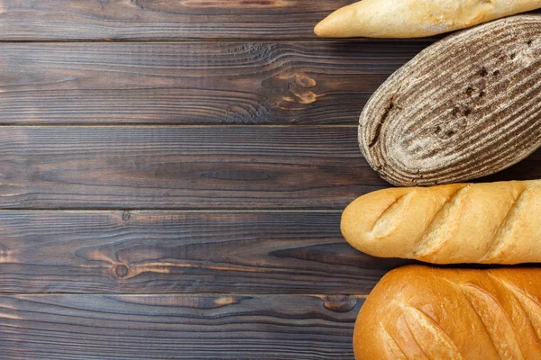 Surtido de pan fresco sobre fondo de superficie de madera — Foto de Stock