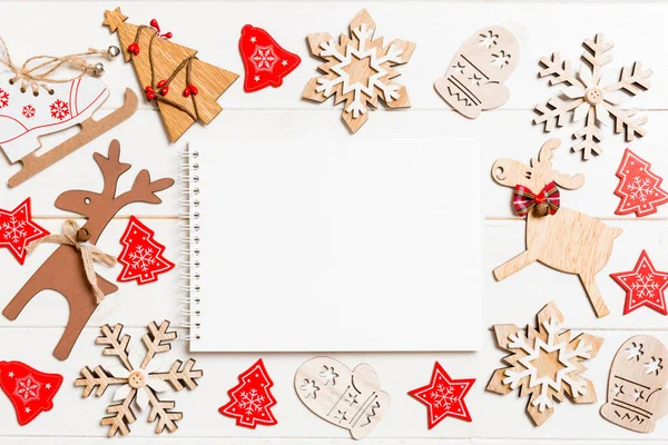 Top view of notebook on wooden background made of Christmas decorations. New Year concept — Stock Photo, Image