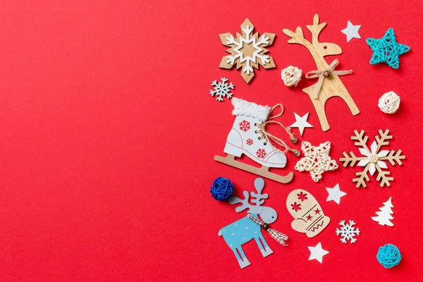 Top view of holiday toys and decorations on red Christmas background. New Year time concept with copy space — Stock Photo, Image