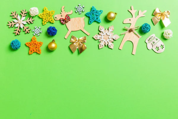 Top view of green background with New Year toys and decorations. Christmas time concept with copy space — Stock Photo, Image