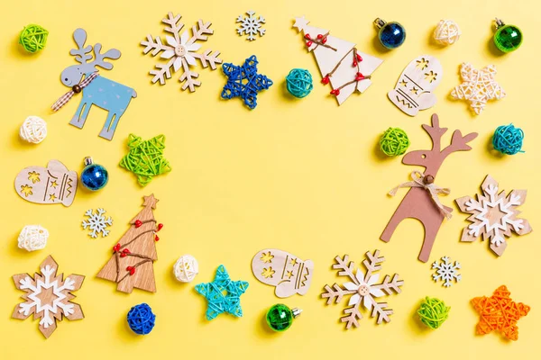 Top view of yellow background with New Year toys and decorations. Christmas time concept with copy space — Stock Photo, Image