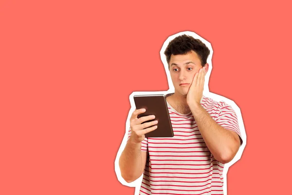 shocked guy looking at camera and holding a tablet computer. emotional guy isolated Magazine collage style with trendy color