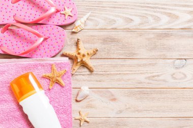 Top view of Beach flat lay accessories. sunscreen bottle with se