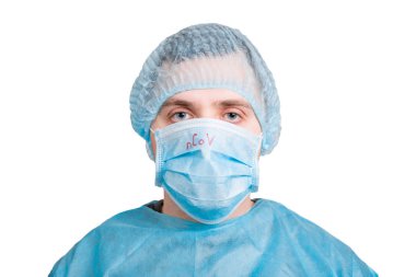 Portrait of young man wearing medical uniform and protective mask with nCoV word isolated on white background. Coronavirus and health care concept