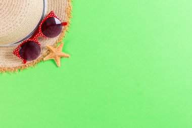 summer holiday beach background with accessories on green table,