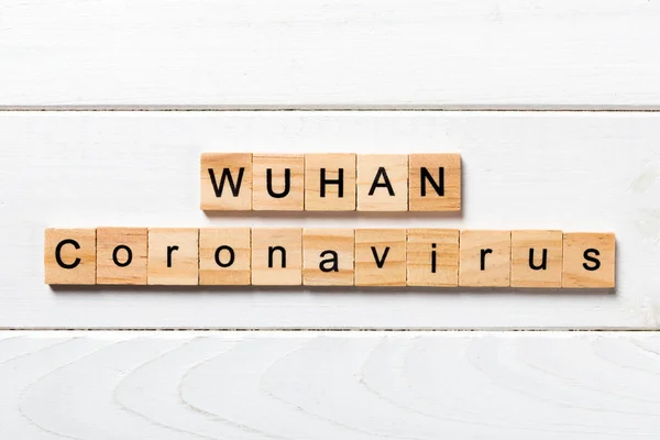 Wuhan coronavirus palabra escrita en bloque de madera. texto sobre tabla de madera para su diseño, Wuhan Coronavirus, 2019-nCoV. concepto vista superior — Foto de Stock