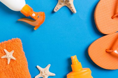 Top view of Beach flat lay accessories. sunscreen bottle with se