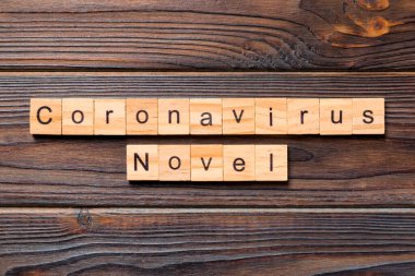 Ahşap blokta yazılmış Coronavirus kelimesi. Ahşap masada 2019-Ncov 'daki Wuhan Coronavirus için yazı var. konsept üst görünüm