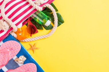 Summer bag background with copy space. Flat lay photo on color t