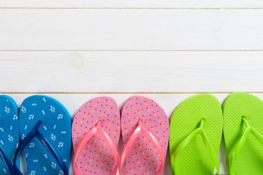 a lot of flip flop colored sandals, summer vacation on wooden ba