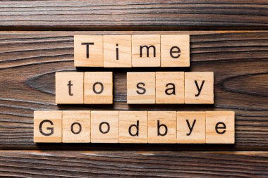 Time to say goodbye word written on wood block. Time to say goodbye text on wooden table for your desing, concept. clipart