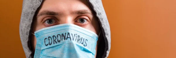 Portrait Young Man Hood Wearing Protective Medical Mask Coronavirus Text — Stockfoto