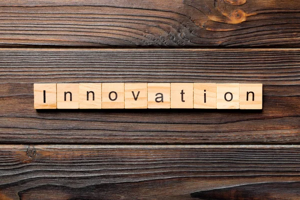 INNOVATION word written on wood block. INNOVATION text on table, concept.