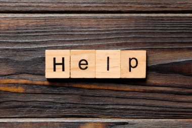 Tahta bloğa yazılmış yardım kelimesi. Tablo, konsept üzerinde yardım metni.