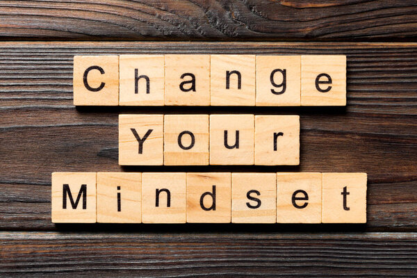 Change your mindset word written on wood block. Change your mindset text on wooden table for your desing, Top view concept.
