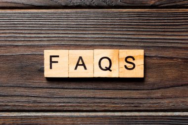 Tahta bloğa yazılmış faqqs kelime. Masada faqs metin, konsept.